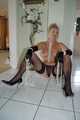 Busty blonde mature Marlen posing topless in gloves and stockings 8