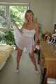 Busty blonde Marlen posing in a white negligee in the bedroom 6