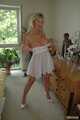 Busty blonde Marlen posing in a white negligee in the bedroom 7
